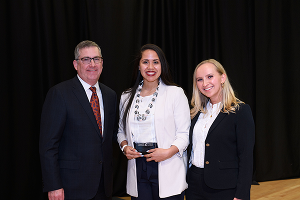 student poses at leadership awards